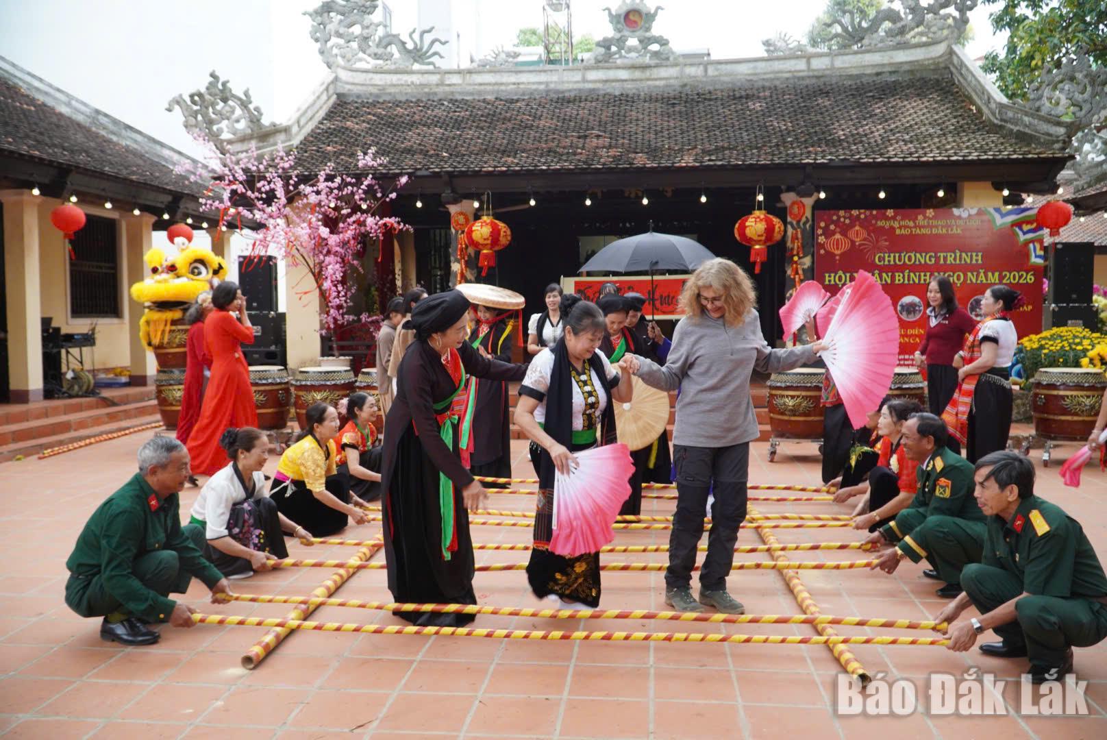 Du khách quốc tế trải nghiệm múa sạp trong hành trình khám phá văn hóa bản địa tại Đắk Lắk.