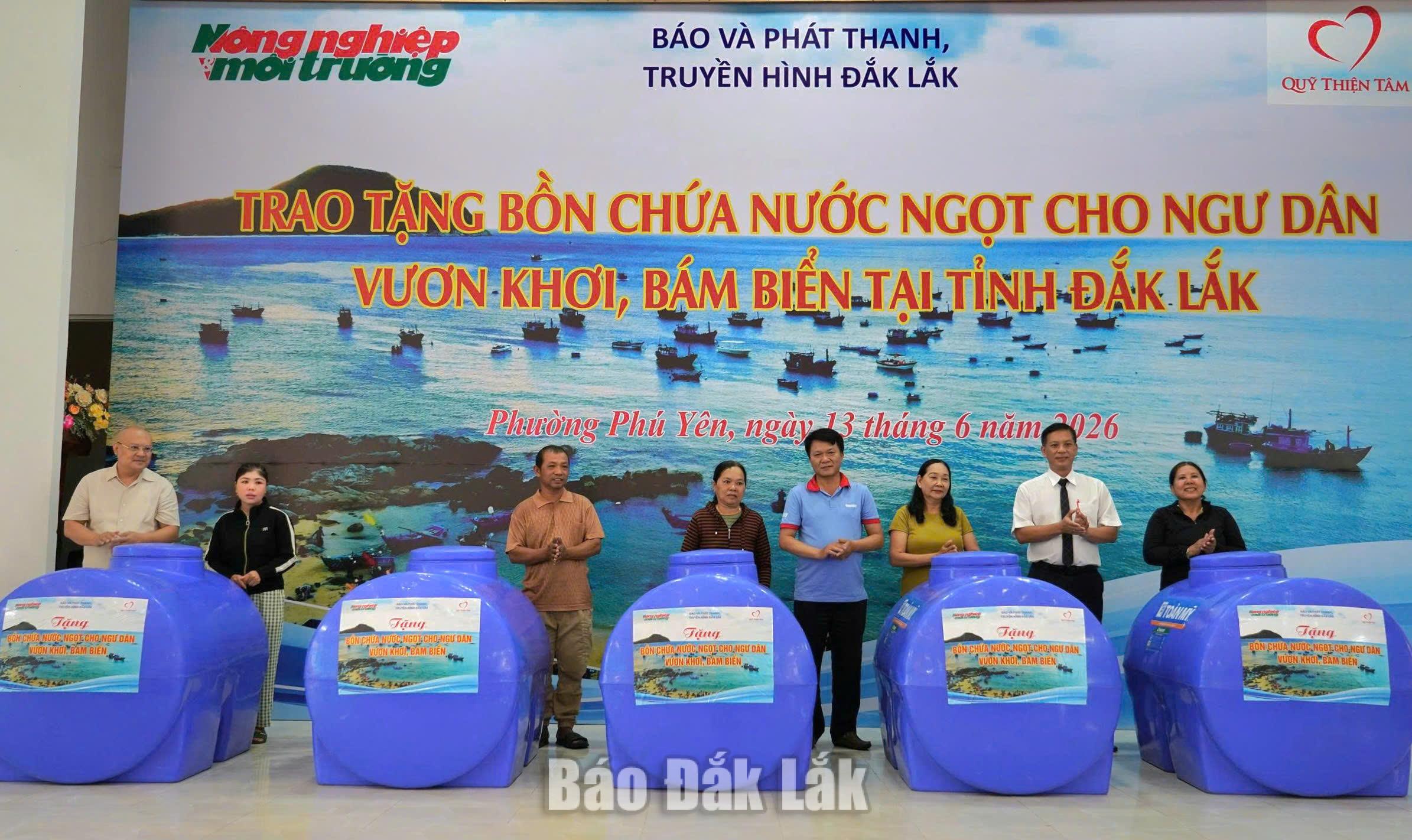 Đại diện Báo Nông nghiệp và Môi trường và phường Phú Yên trao tặng bồn nước cho ngư dân phường Phú Yên. Ảnh: T.Hương