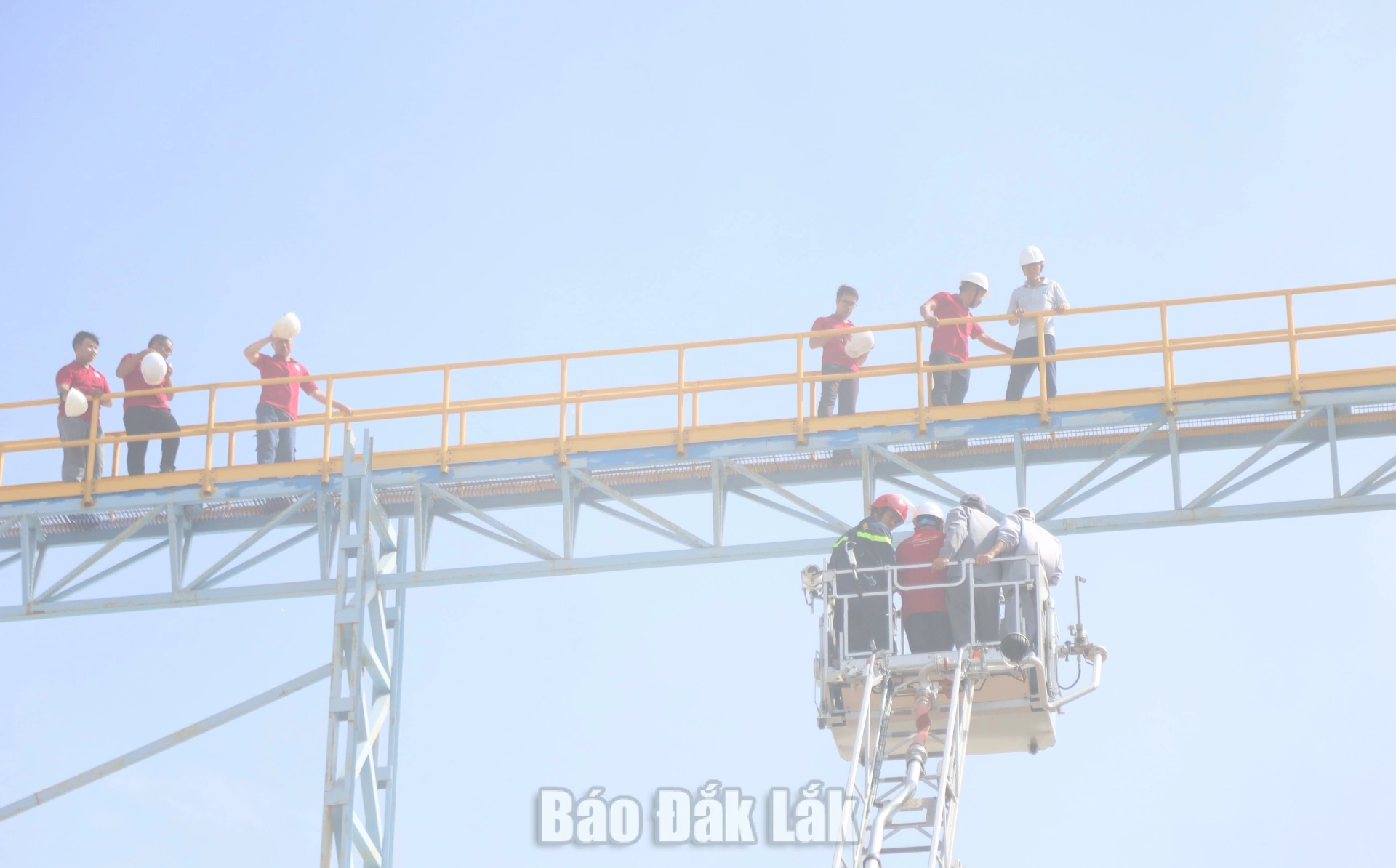Những người bị mắc kẹt trên cao được hỗ trợ đưa xuống bằng xe nâng...