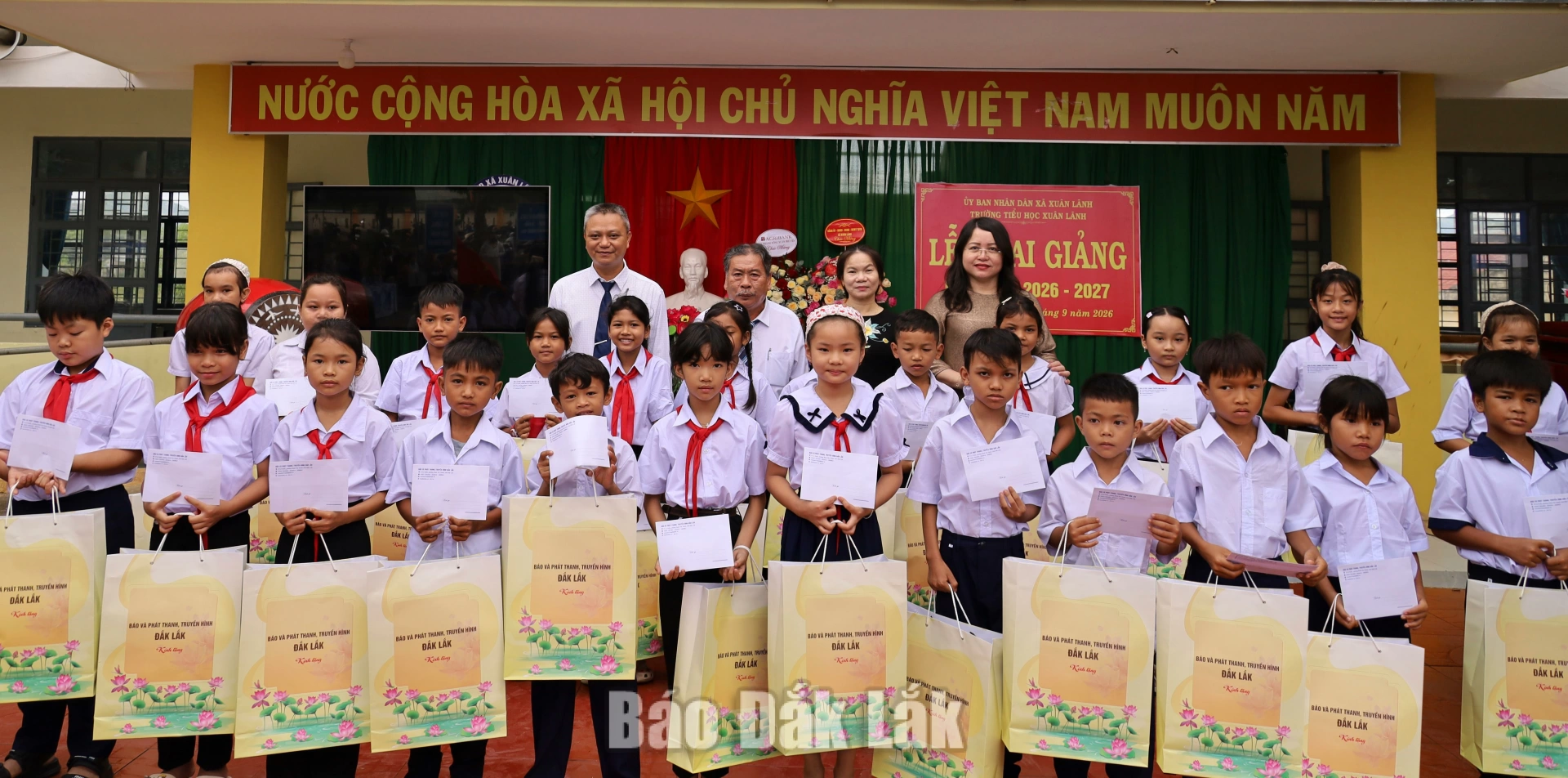 Tỉnh ủy viên, Giám đốc Báo và PTTH Đắk Lắk Đào Phạm Hoàng Quyên cùng lãnh đạo xã Xuân Lãnh trao học bổng cho các em học sinh nghèo vượt khó Trường Tiểu học Xuân Lãnh. Ảnh: Ngọc Thắng
